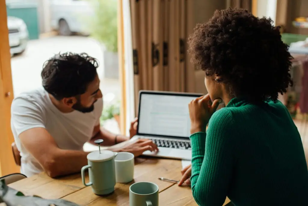UK couple reviewing a legit wedding competition entry on laptop