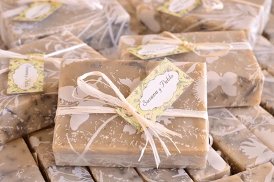 Wrapped artisan soaps with decorative bows, a luxurious and practical wedding guest gift.