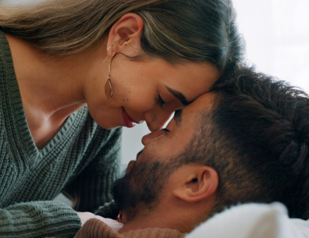 A tender moment between a couple, symbolizing the fulfillment of the wedding planning timeline before their special day.