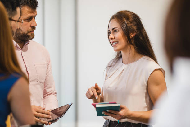 A wedding planner consulting with a couple, likely discussing final arrangements or addressing any concerns, highlighting their role in ensuring a smooth ceremony and celebration.